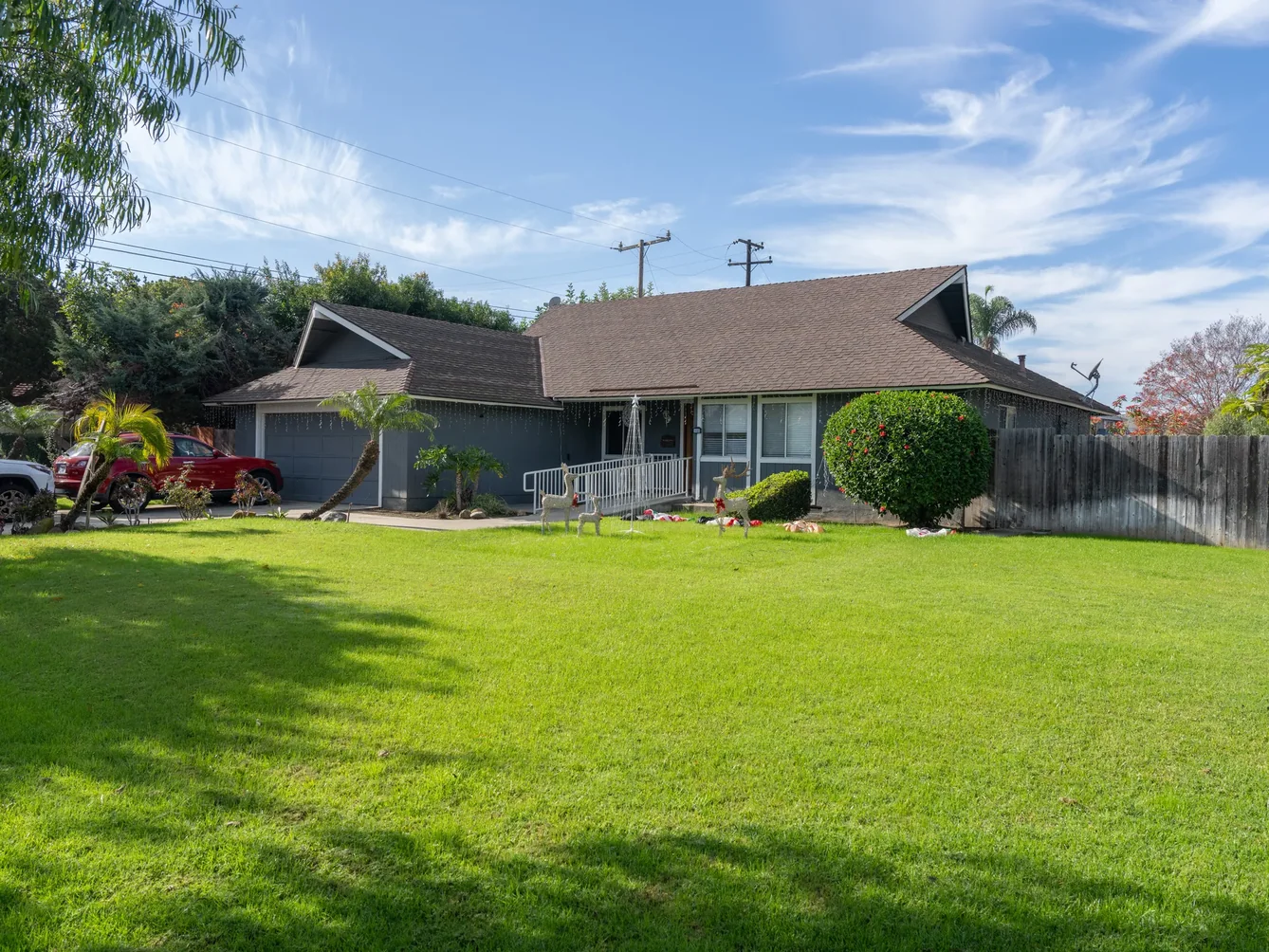 Exterior view of single-story residential care home with manicured lawn and accessible front entrance